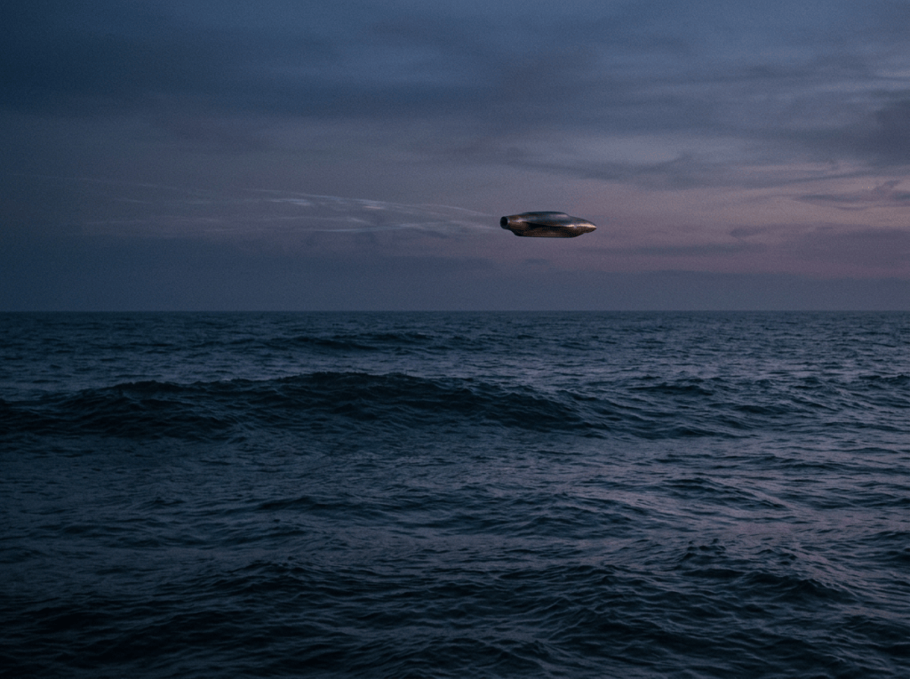 Cigar-shaped unidentified object hovering above a dark ocean at twilight